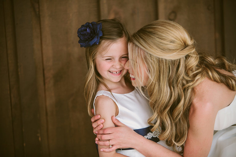 Bride hugging her flower girl