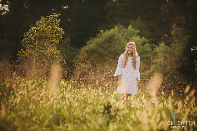 Casey walking through a field during her senior session near Chattanooga, Tennessee