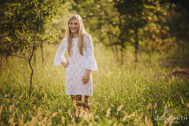 Casey standing, looking at the camera and smiling during her senior session at the Chickamauga Battlefield in Georgia