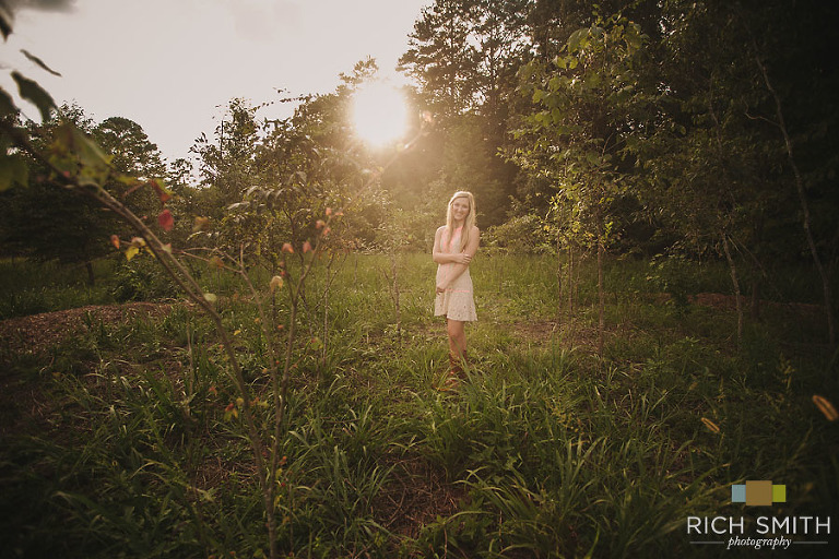 A far away shot of Casey in a gorgeous field during her senior session near Chattanooga