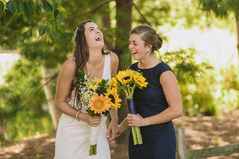 bride and bridesmaid, laughing, wedding day
