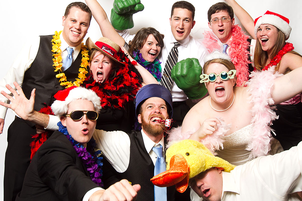 Wedding party having fun in photo booth