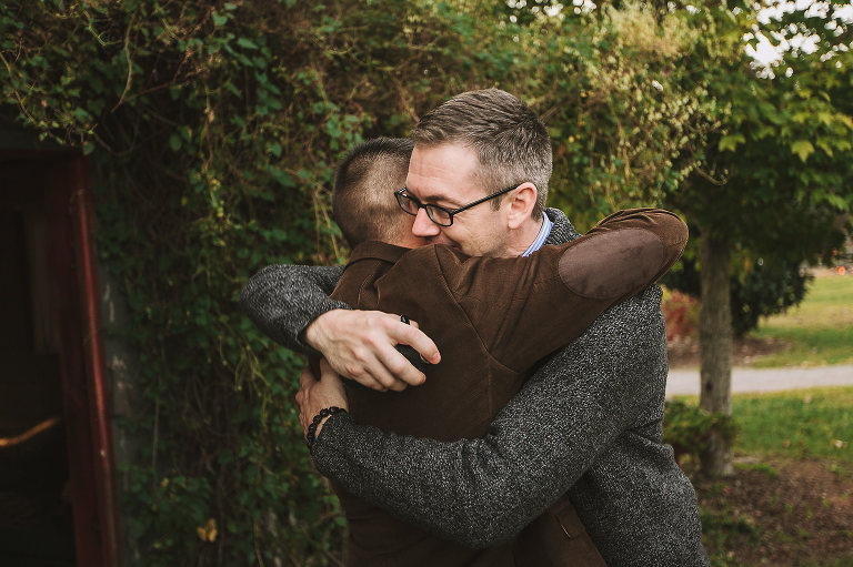 wedding day, barn wedding, groom, pastor, hugging