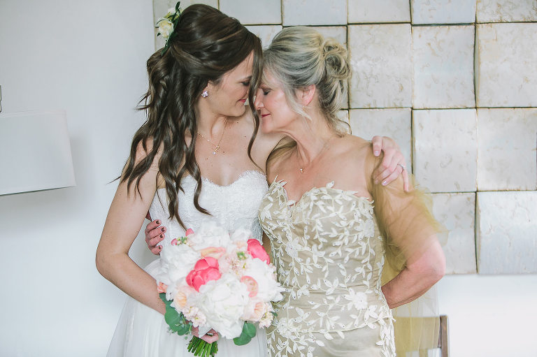 bride and mother of the bride, hugging, emotional