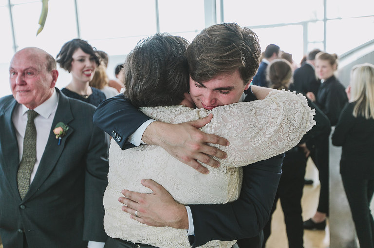 groom hugging his mother, mother of the groom, wedding day