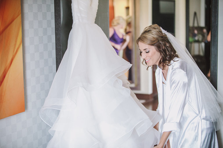 bride getting ready for her wedding day with her wedding dress