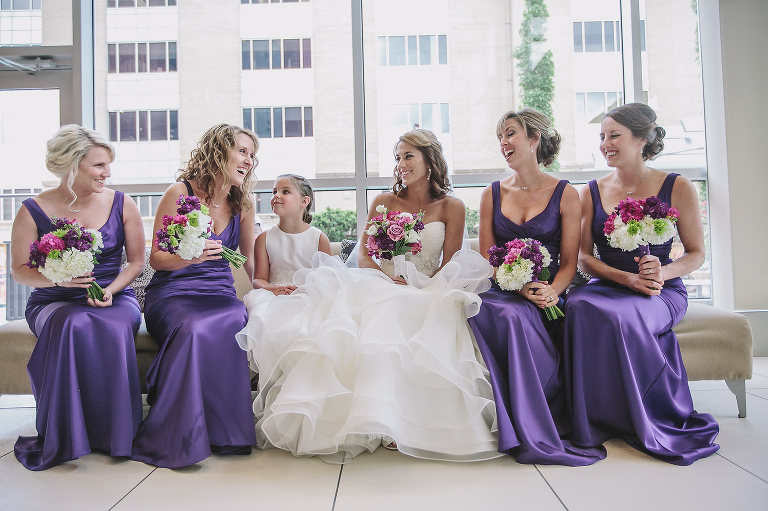 bride with her bridesmaids and flower girl laughing