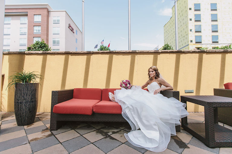 bride posing on a sofa before her wedding