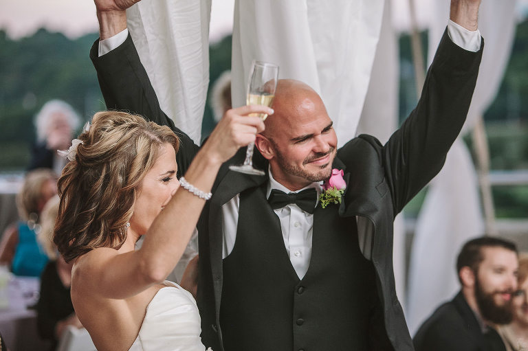 bride and groom laughing during toasts