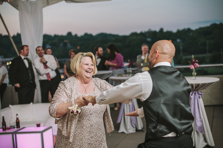 groom dancing with his mom and laughing 