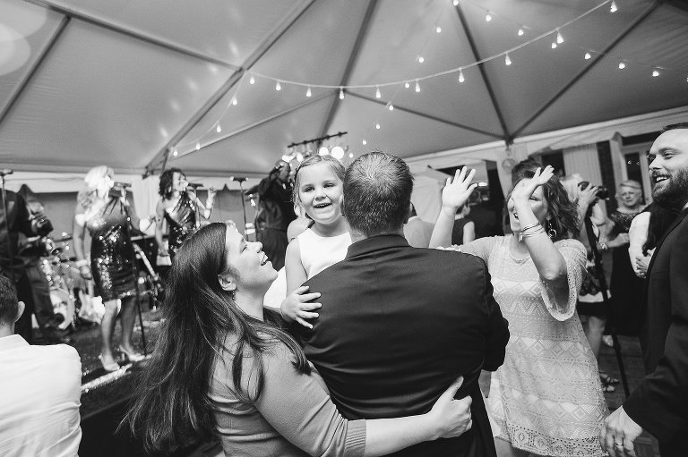 wedding guests laughing and dancing at reception 