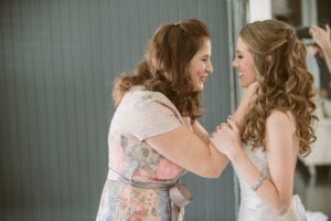 mom having a moment with the bride