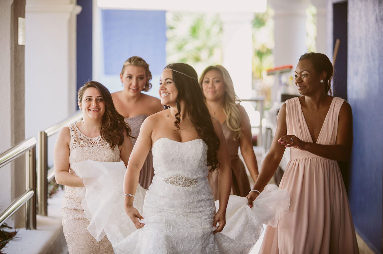 bride and bridesmaids walking outside laughing 
