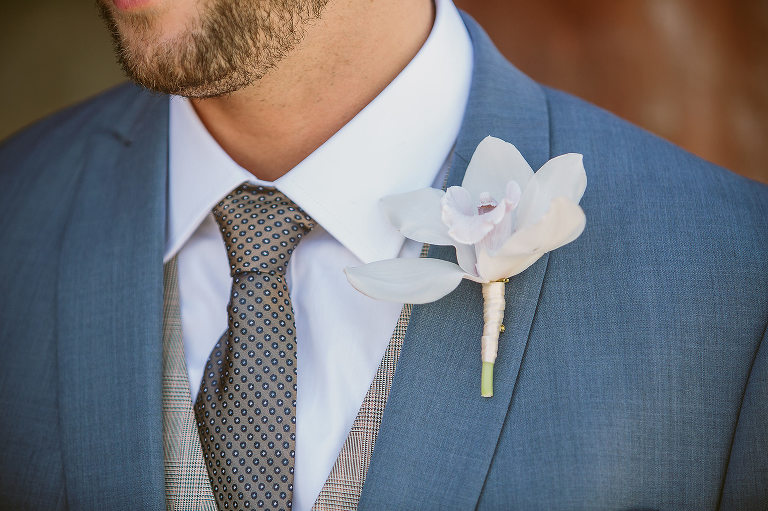 grooms boutonniere and tie close up 