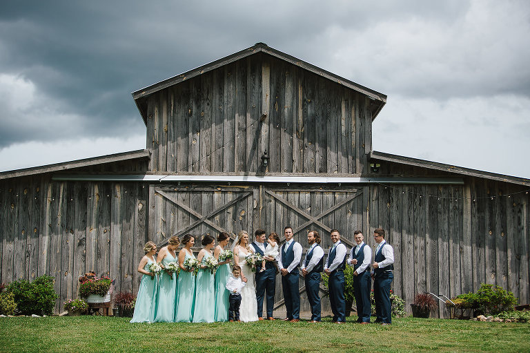wedding party in front of barn