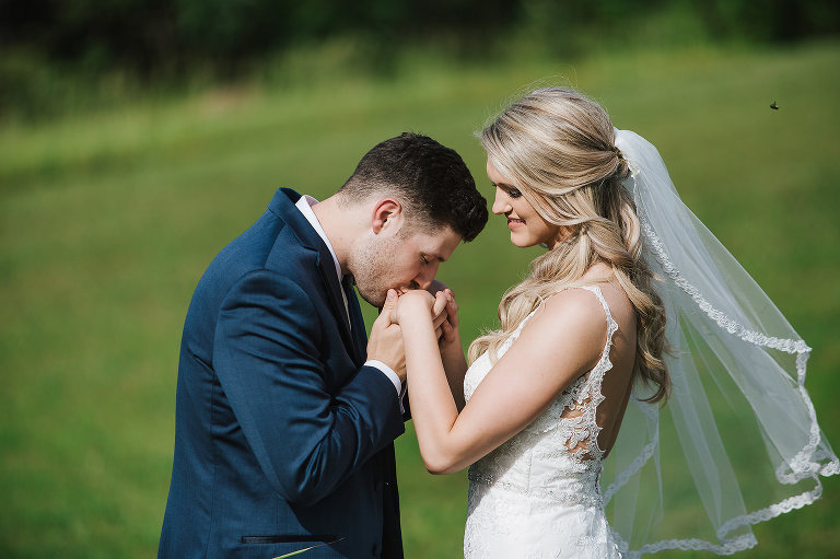 groom kissing grooms hands