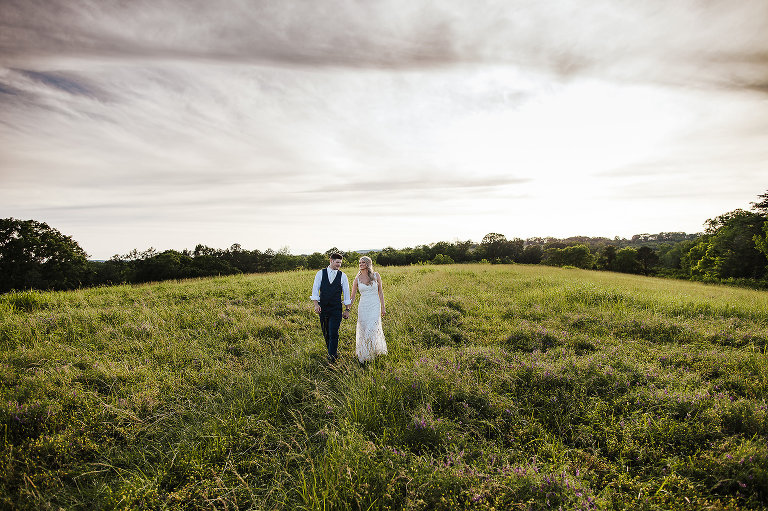 bride and groom portrait in field 