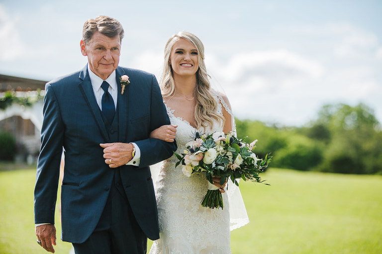 bride with her father walking her down the aisle