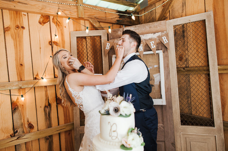 bride and groom cut wedding cake