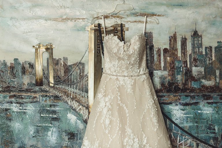 bridal gown in front of painting 