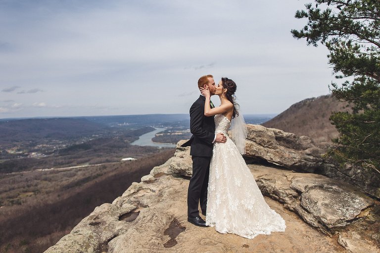 bride and groom kissing on sunset rock lookout mountain 