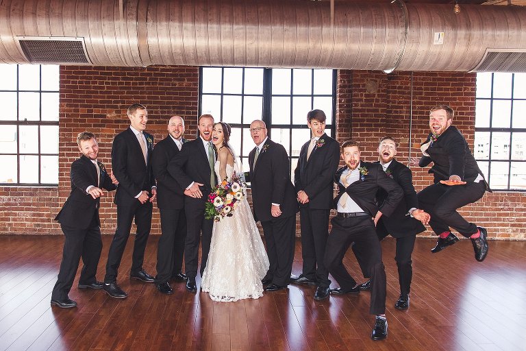 bride with groomsmen laughing and energetic 