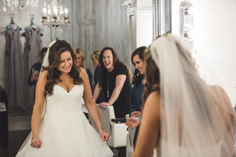 bride excited after putting on wedding dress