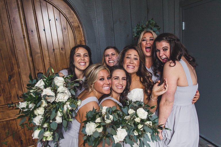 bride and her girls pose right after ceremony
