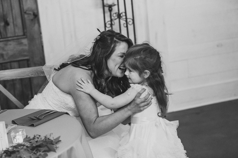bride playing with the flower girl