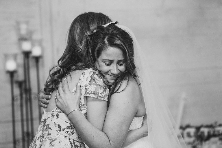 bride hugs her mom during her reception