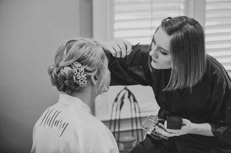 bride having her makeup done by makeup artist