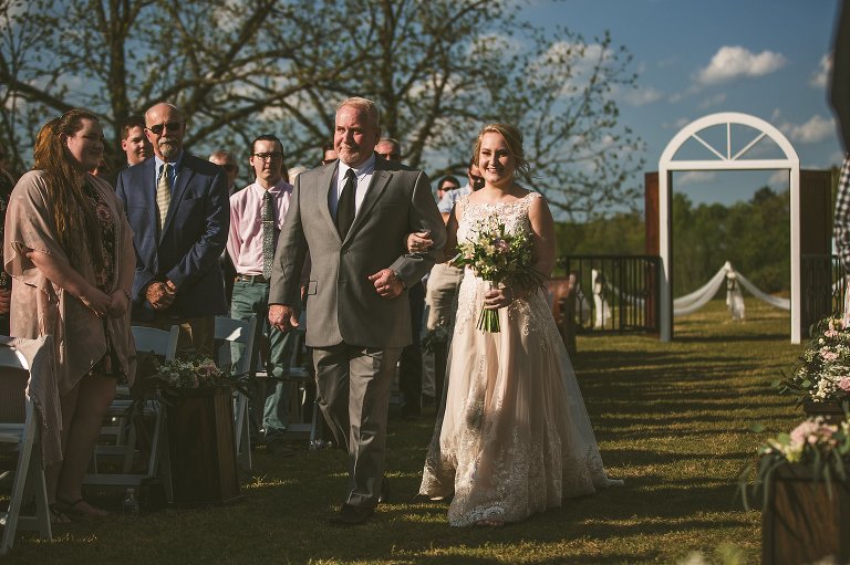 bride waking down aisle with her dad