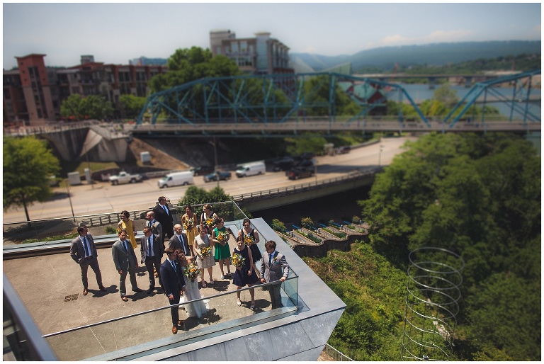 wedding party in downtown chattanooga with walking bridge in background 