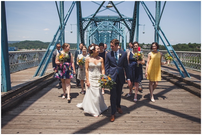 bride and groom with wedding party on the walking bridge downtown chattanooga 
