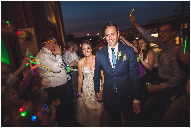bride and groom exit with glow sticks 