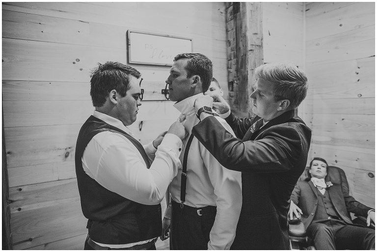 groom getting ready groomsmen helping 
