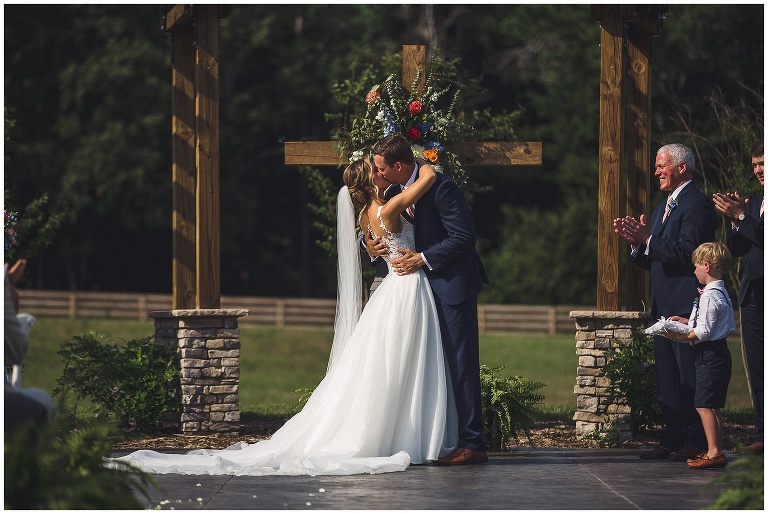 groom kisses his bride for the first time as a married couple!