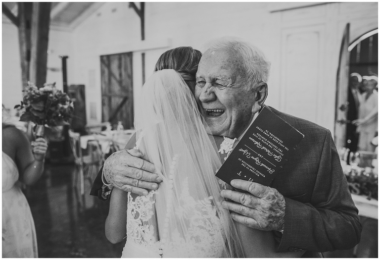 grandfather hugs his granddaughter after she got married.