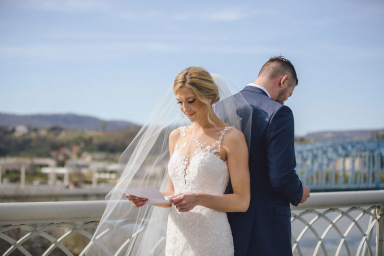 bride and groom reading letters back to back
