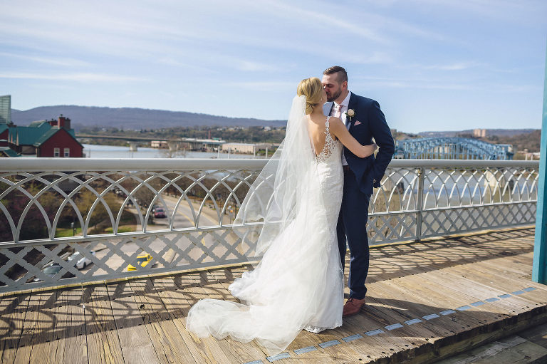 bride and groom kiss on waking bridge chattanooga