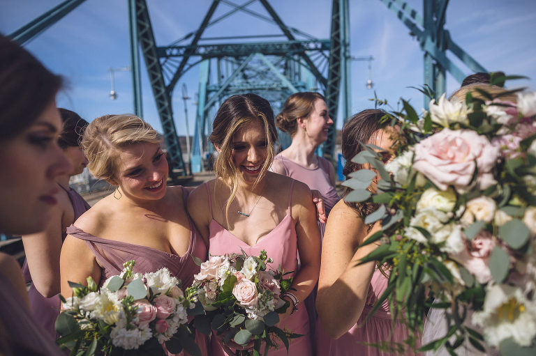 bridesmaids joining bride and groom on bridge