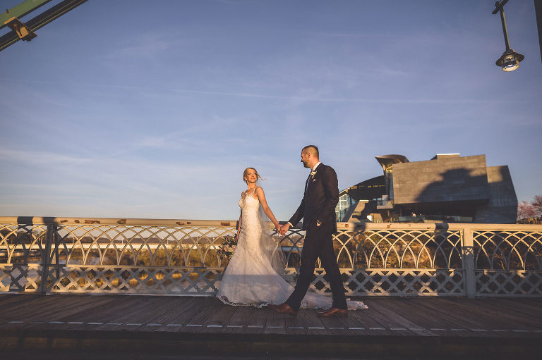 bride and groom walking bridge 