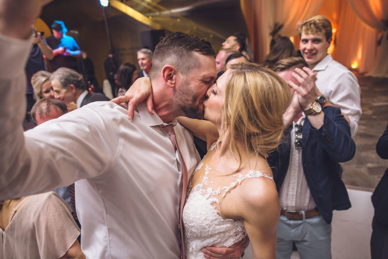 bride and groom kiss at reception hunter museum