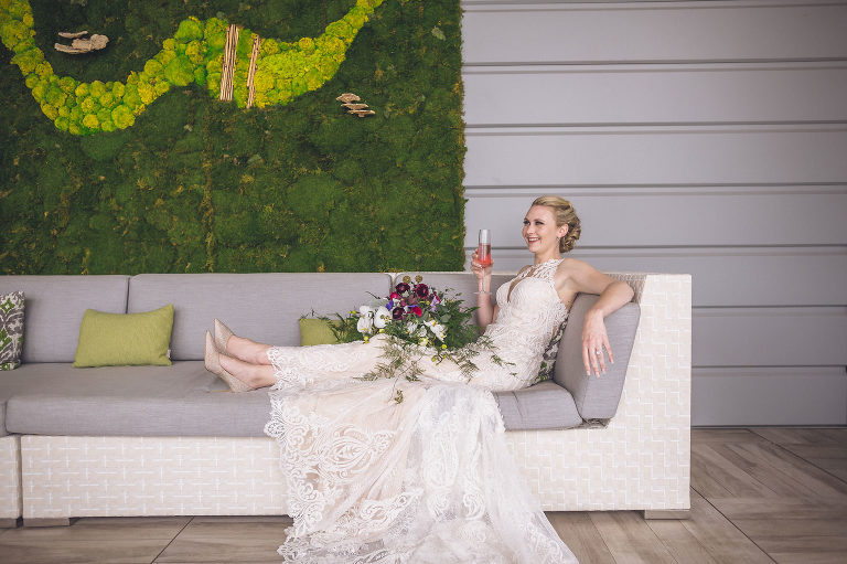 bride reclining on sofa with pink drink