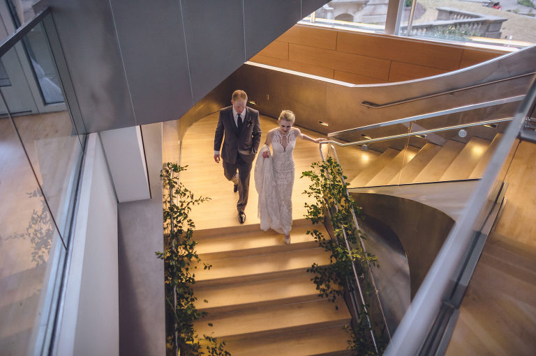 bride and groom walking downstairs at the hunter museum 